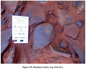 A hand-axe pictured as it was found. Complete specimens are not common probably because they were not used here and so they would have been taken elsewhere to be used. This one was probably lost in the sand and rock after production.  Image from Walker et al. 2013 report:  A second phase 2 archaeological data recovery at the site of Kathu Townlands of Erf5116.